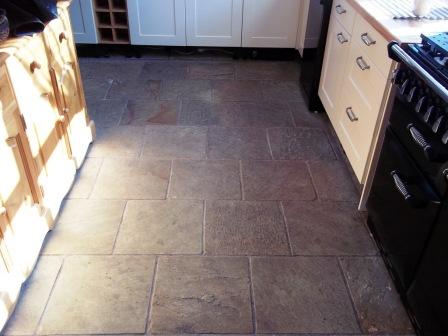 Picture shows Indian Sandstone kitchen floor before cleaning and sealing