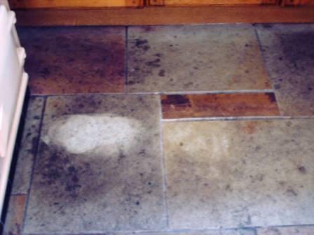 Picture shows Sandstone kitchen floor before cleaning and sealing